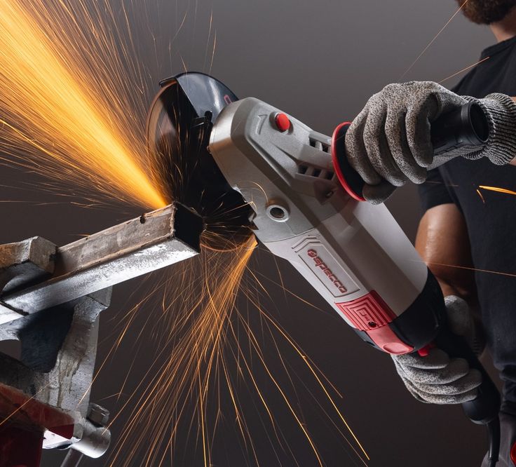 Angle grinder cutting metal with sparks